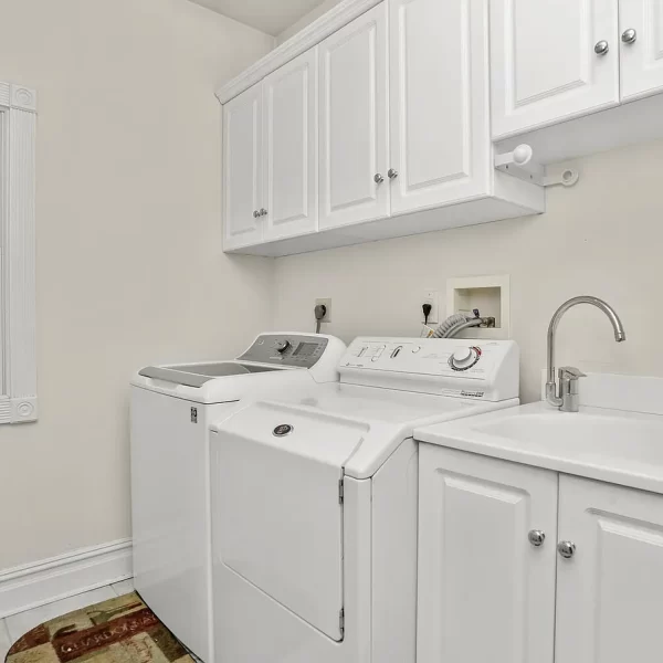 Two laundry machines under the cabinetry