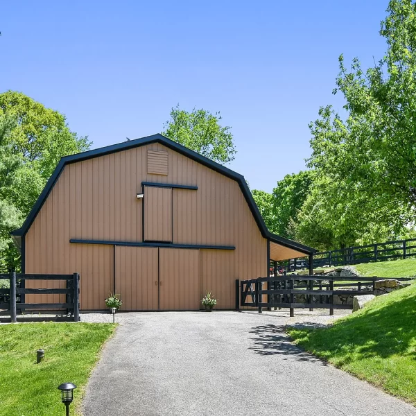A peach colored barn with black features